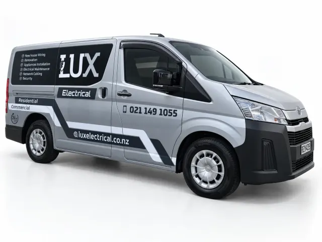 Front-quarter view of a silver LUX Electrical van with white lettering and dark geometric side graphics.