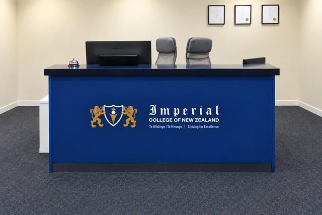 Blue Imperial College reception counter with a gold crest and white college name.